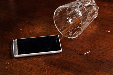 Smartphone in water on the tableの写真素材