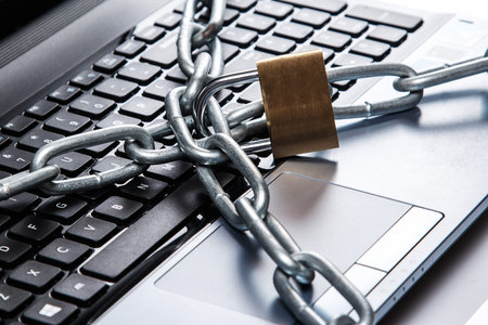 Padlock and chain on a laptop keyboard. Concept of internet security