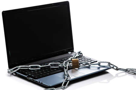 Padlock and chain on a laptop keyboard. Concept of internet securityの写真素材