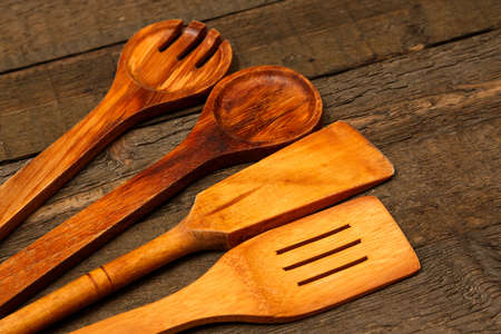 Wooden kitchen utensils on the tableの写真素材