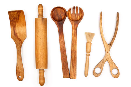 Wooden kitchen utensils on white background