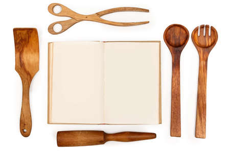 Wooden kitchen utensils and recipe book on white backgroundの写真素材