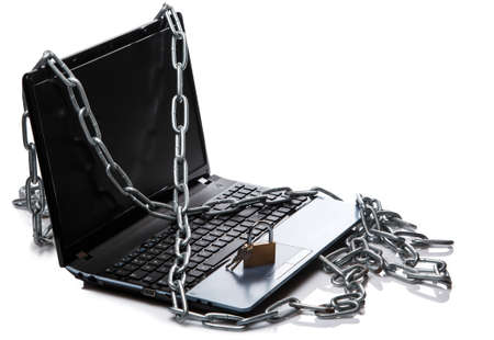 Padlock and chain on a laptop keyboard. Concept of internet securityの写真素材