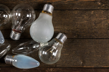 Different lightbulbs on wooden background