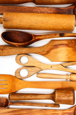 Wooden kitchen utensils on white background