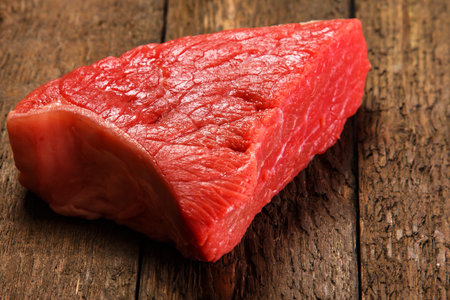 Raw meat on wooden table