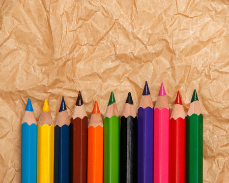 Multicolored pencils  over crumpled paper surfaceの写真素材