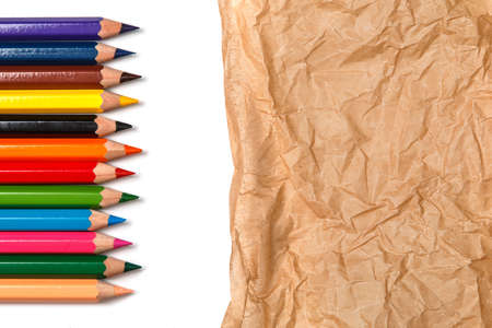 Multicolored pencils  over crumpled paper surfaceの写真素材
