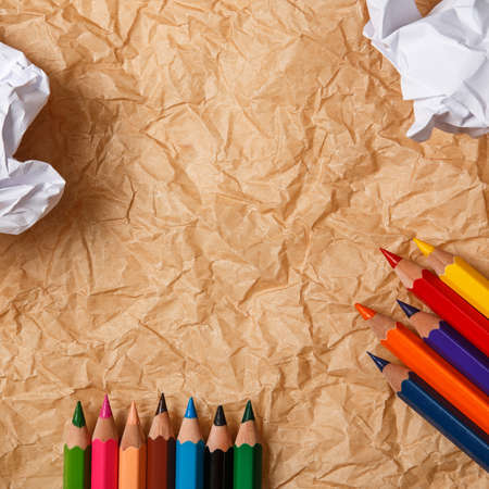 Multicolored pencils and crumpled paperの写真素材