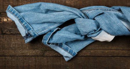 Blue jeans on old wooden surfaceの写真素材