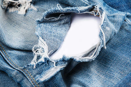 Closeup of jeans texutre with a holeの写真素材