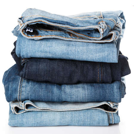 Stack of different blue jeans on white backgroundの写真素材