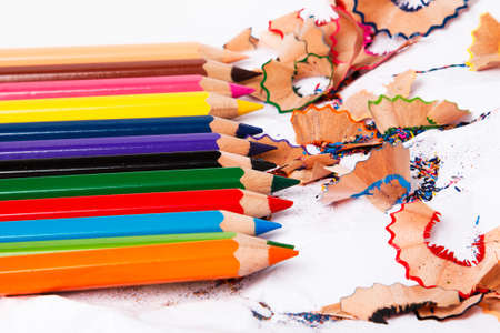 Multicolored pencils and shavings on white backgroundの写真素材