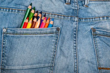 Multicolored pencils in the pocket of jeansの写真素材