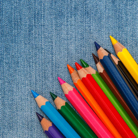 Multicolored pencils over jeans surfaceの写真素材