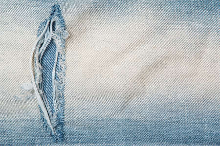 Closeup of jeans texutre with a holeの写真素材