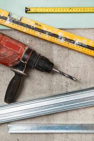 Drill and level tool on dirty floor