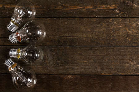 Glowing lightbulbs on wooden backgroundの写真素材