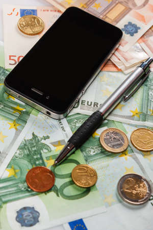 Smart phone, pen and eurosの写真素材