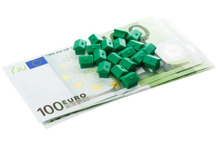 Small toy houses and euro banknotesの写真素材
