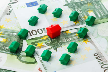 Small toy houses and euro banknotesの写真素材
