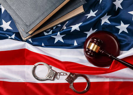 Gavel, books and handcuffs over american flagの写真素材