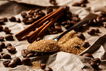 Close up of spoon with brown sugar and coffee beansの写真素材