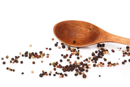 Wooden spoon and dried pepper seeds on white backgroundの写真素材