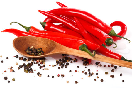 Red chili and dried pepper seeds on white background