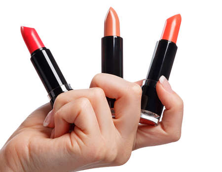 Lipsticks in hand over white backgroundの写真素材
