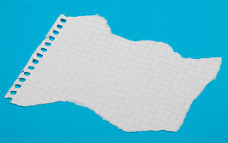 Torn pieces of checkered paper on blue backgroundの写真素材