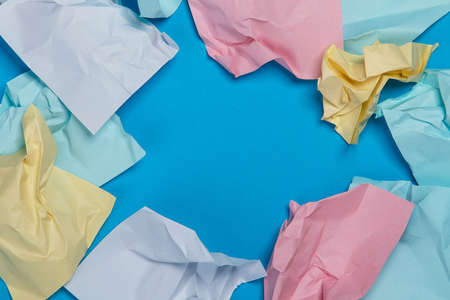 Crumpled colorful stickers on blue surfaceの写真素材