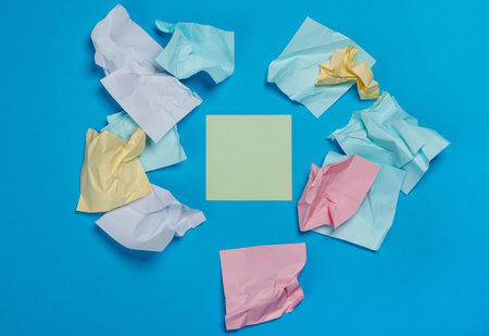 Crumpled colorful stickers on blue surface