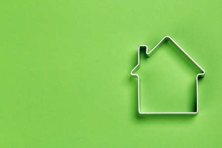 Small abstract model of house on green backgroundの写真素材