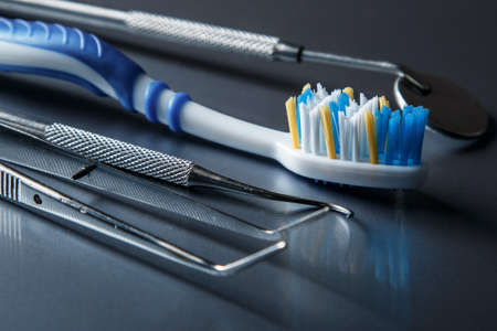 Toothbrush and dental equipment on metal surfaceの写真素材