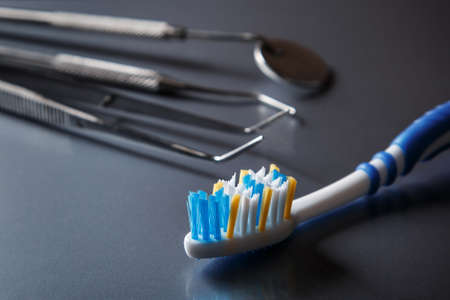 Toothbrush and dental equipment on metal surfaceの写真素材