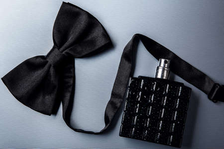 Bottle of male perfume and black bow tieの写真素材