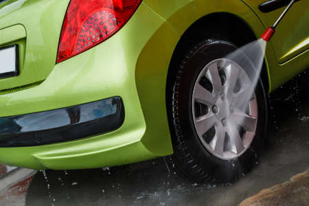 Green modern automobile in the car washの写真素材