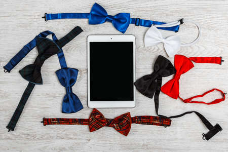 Set of different bow ties and tablet pcの写真素材