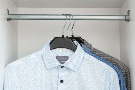 Different shirt in the closet on hangersの写真素材