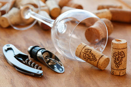 Wine tools and corks on wooden surfaceの写真素材