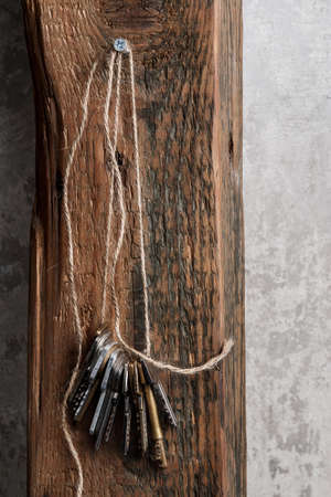 Different keys on thread over wooden surfaceの写真素材
