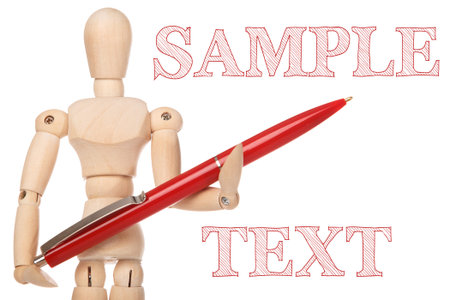 Small wooden dummy and ballpoint pen on white backgroundの写真素材