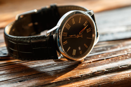 Expensive wrist watch on wooden surface