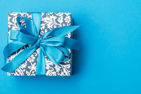 Blue gift box on light blue backgroundの写真素材