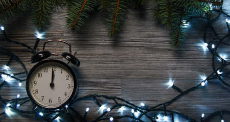 Christmas background. Alarm clock and christmas lightsの写真素材