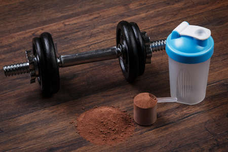 Heavy black dumbell and protein powderの写真素材
