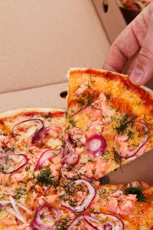Delicious pizza with salmon and onionの写真素材
