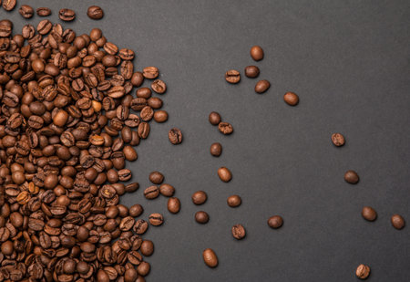 Coffee beans on a grey paper surfaceの写真素材