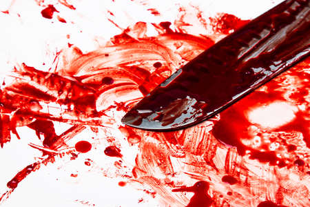 Knife in blood on white backgroundの写真素材